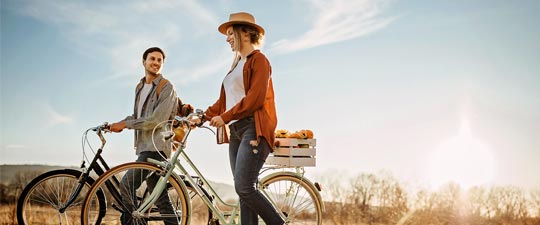 Young couple biking together outside