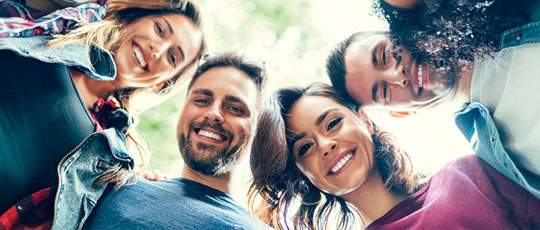group of young diverse people smiling at the camera